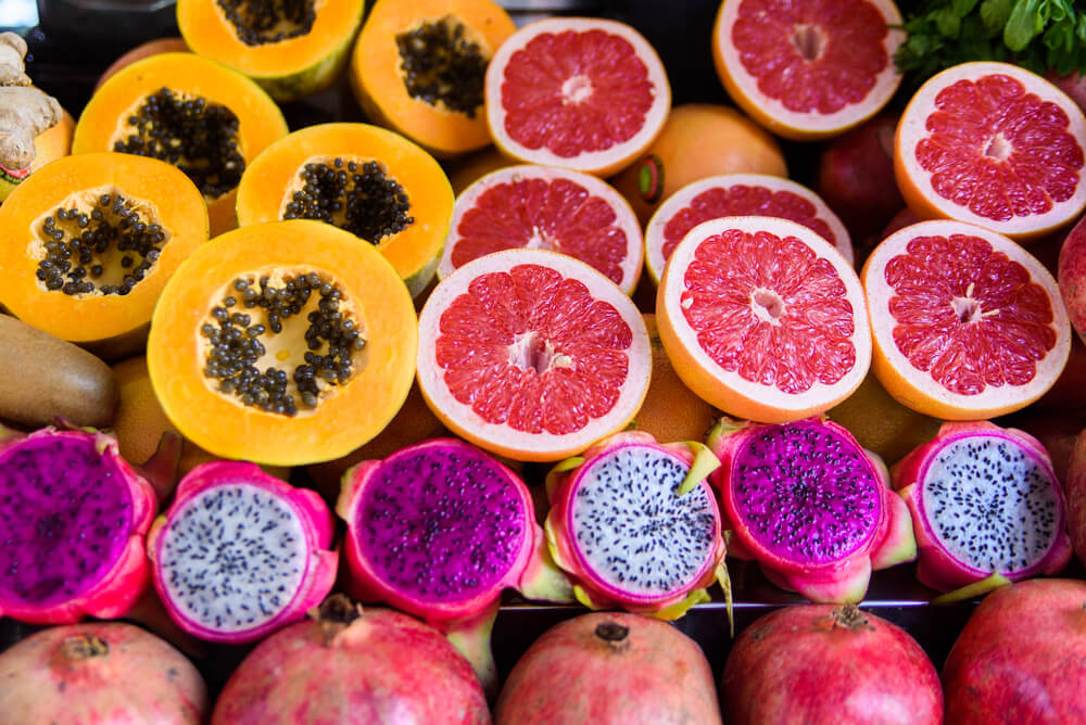 Image of tropical fruit sliced in half and presented at an Oahu farmers market in Hawaii.