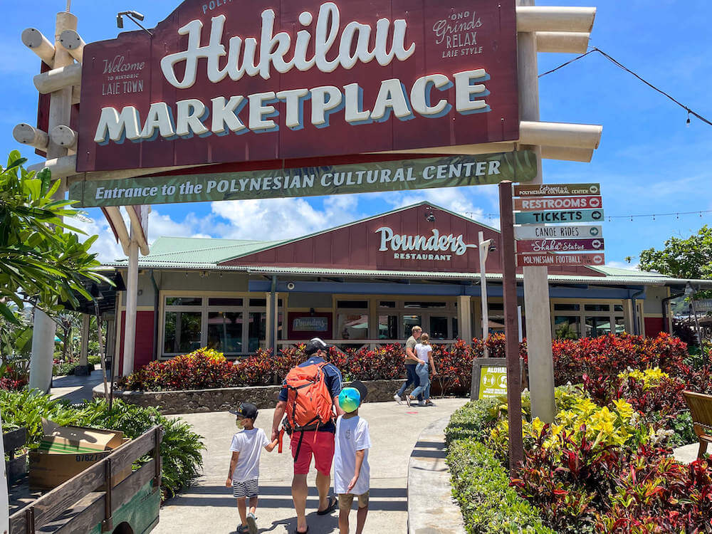 Some of the best Oahu gift shops are at the Hukilau Marketplace at the Polynesian Cultural Center. Image of the Hukilau Marketplace sign.