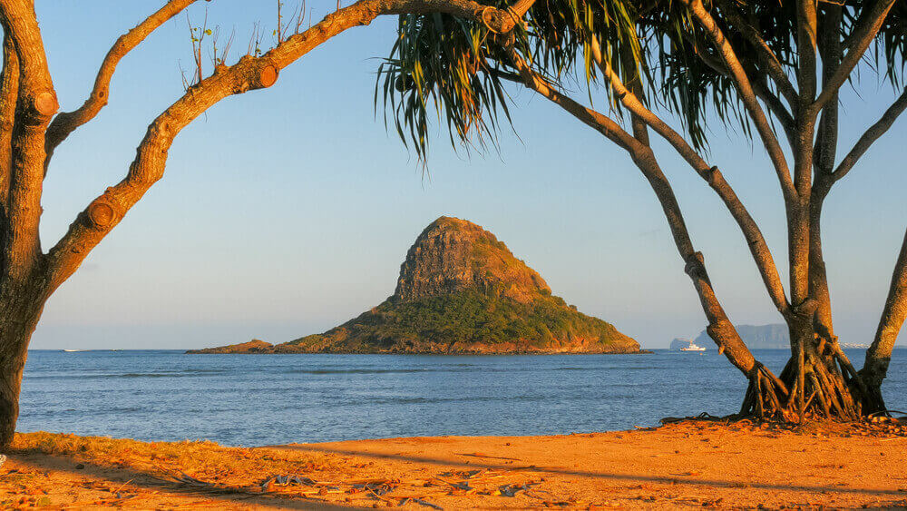 Image of Chinaman's Hat (an island) in the water off the coast of Kualoa Beach Park on Oahu.