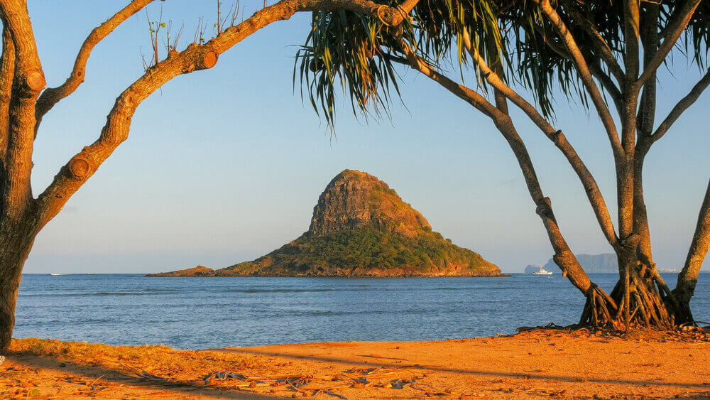 Image of a little island off the coast of Oahu at Kualoa Beach Park.