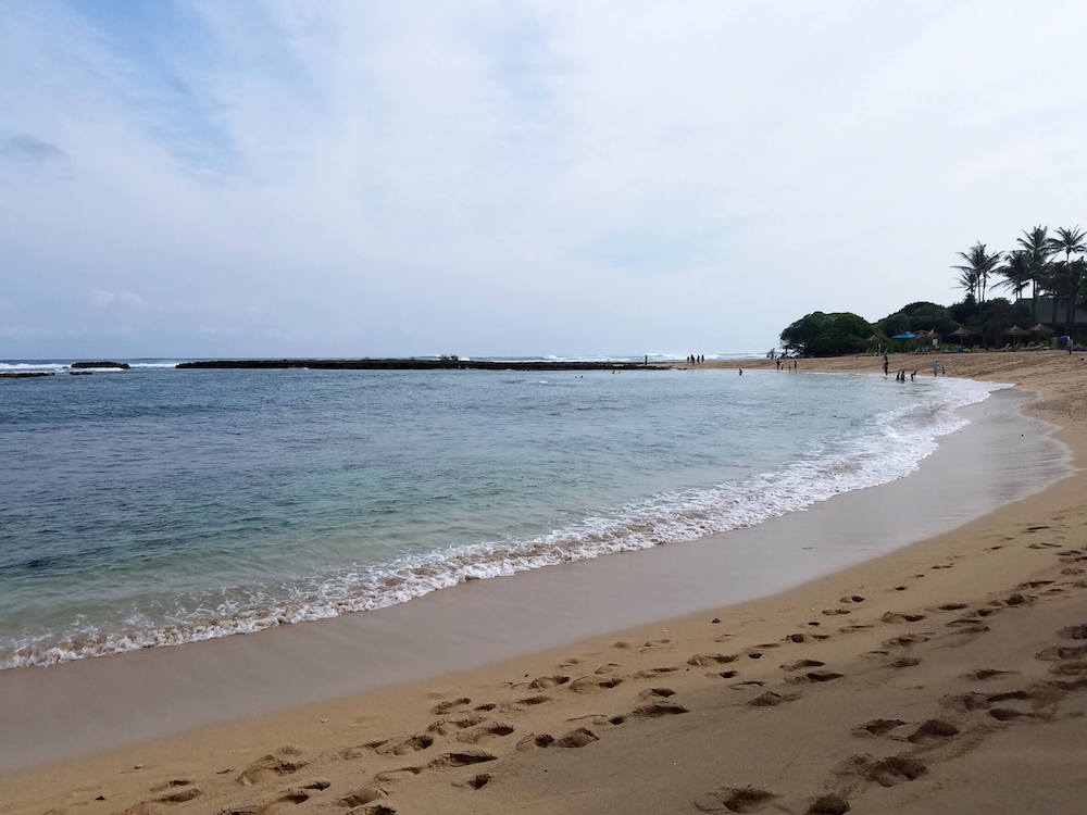 Kuilima Cove is one of the best places to snorkel on Oahu North Shore. Image of a calm beach in Hawaii.