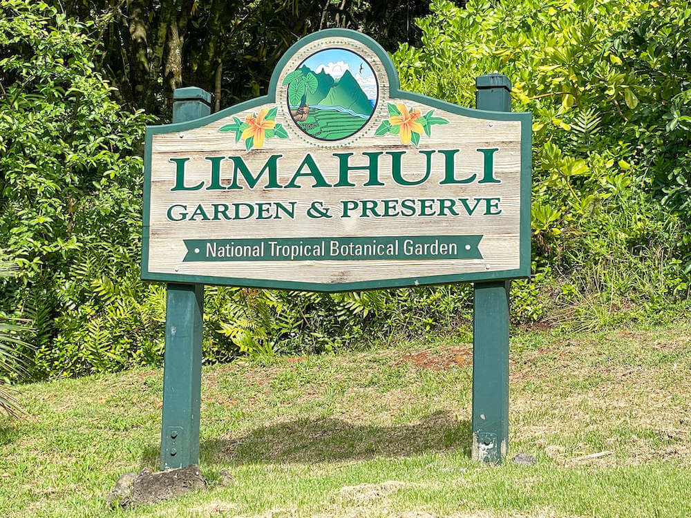 Should you explore the Limahuli Garden in Hanalei Kauai? Read this review by top Hawaii blog Hawaii Travel with Kids. Image of the Limahuli Garden sign.