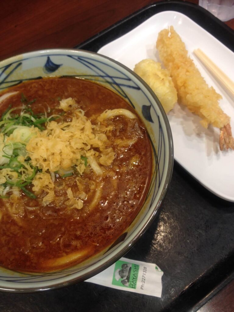 Image of curry udon and shrimp tempura at Marukame Udon in Waikiki, Oahu.