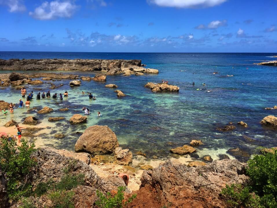 Sharks Cove is one of the best places to snorkel on Oahu. Image of a rocky reef with calm water.