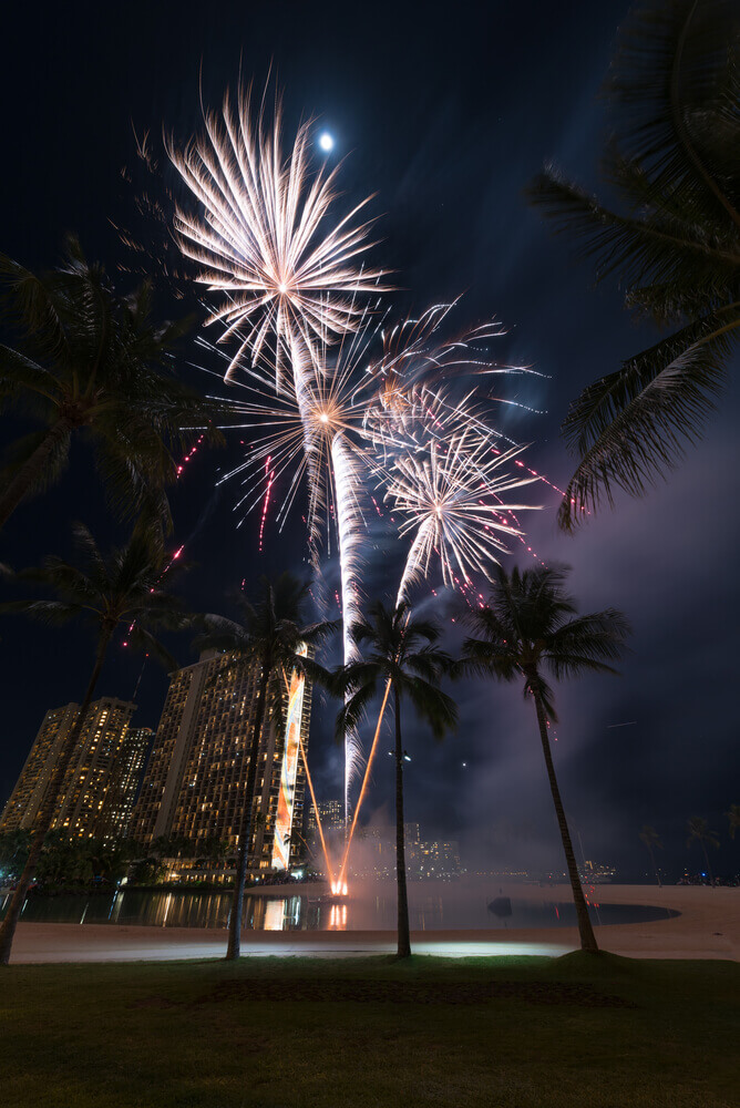 Image of fireworks outside the Hilton Hawaiian Village in Waikiki to celebrate New Year's Eve in Hawaii.