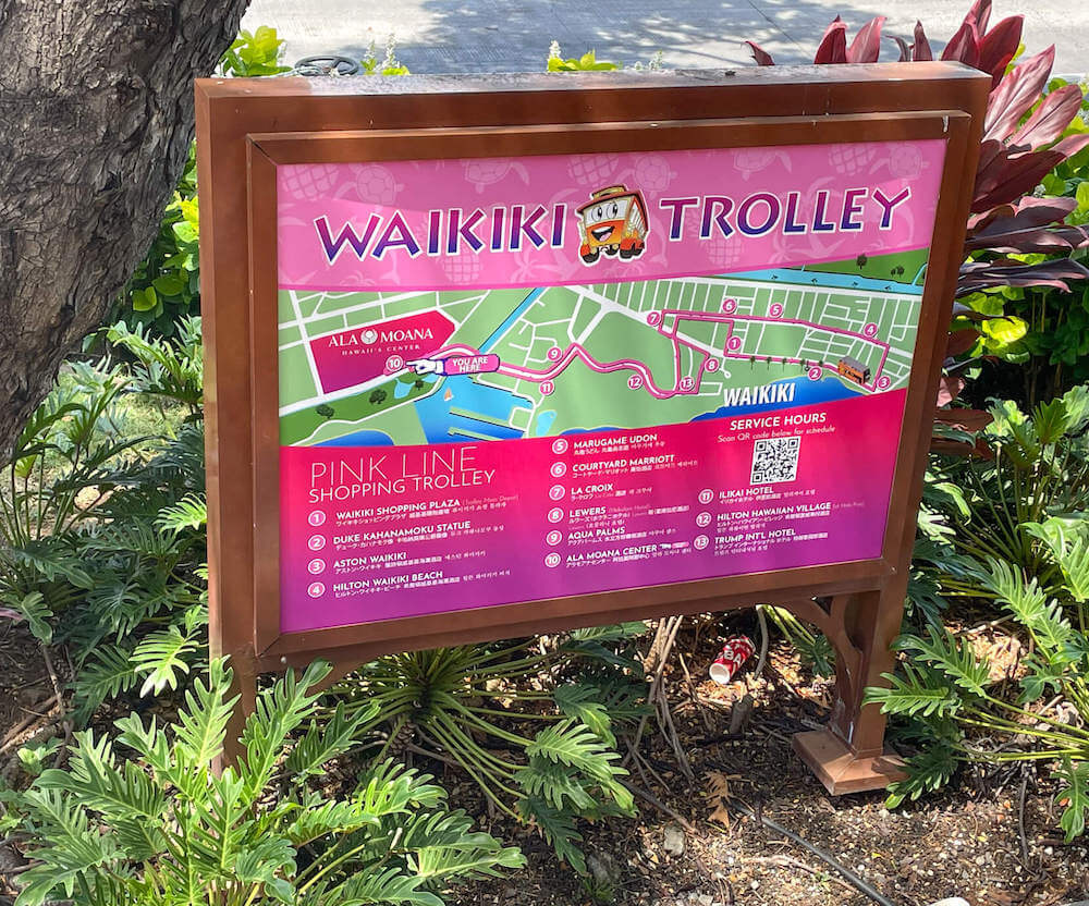 Find out whether or not the Waikiki Trolley Pink Line is worth it. Image of a pink Waikiki Trolley sign and map.