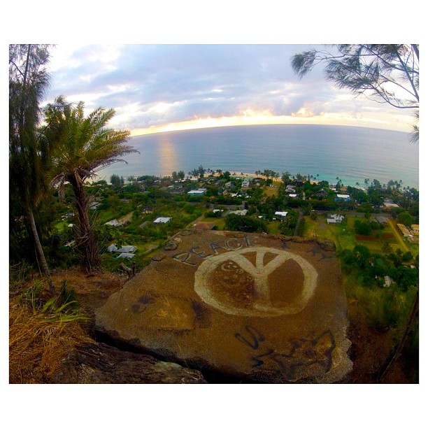 Image of the Ehukai Pillbox on Oahu where you can see a peace sign painted on the large stone slab.