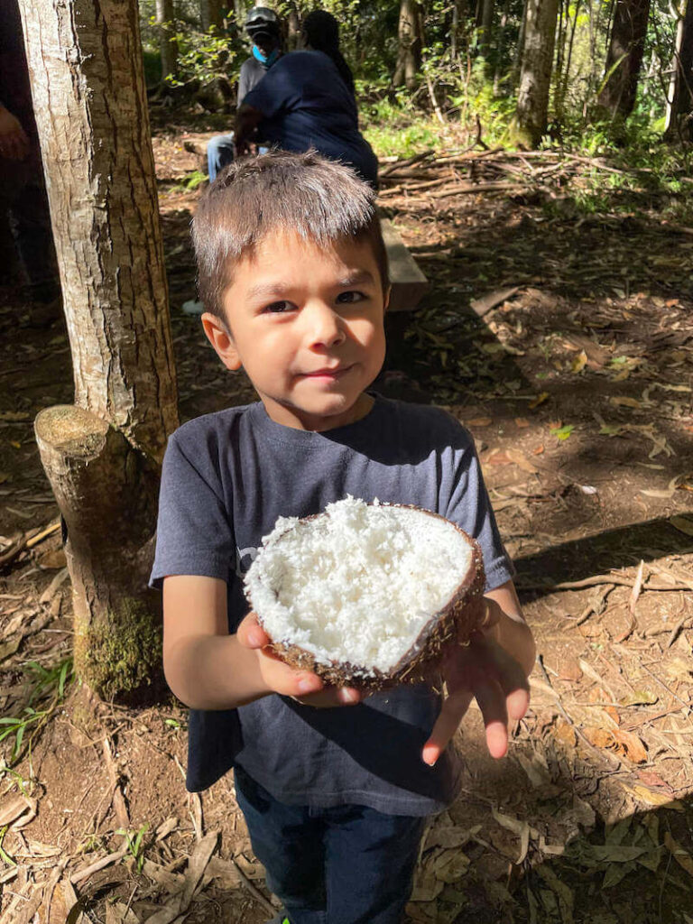 Image of a boy holding a bowl of freshly shaven coconut.