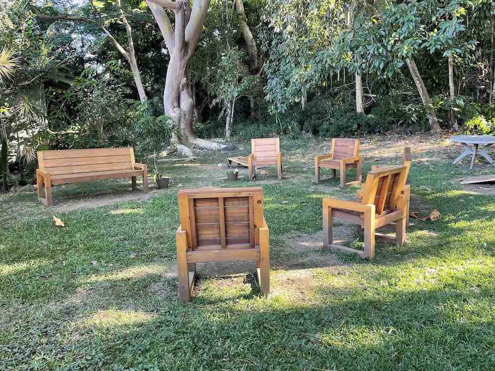 Image of wooden chairs and benches in a circle outside at a Big Island ATV tour.