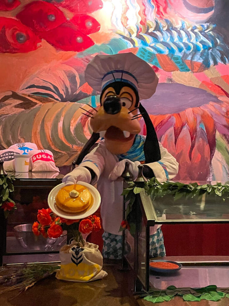 Image of Chef Goofy holding a plate of fake pancakes at a photo spot at Disney Aulani Resort in Hawaii.