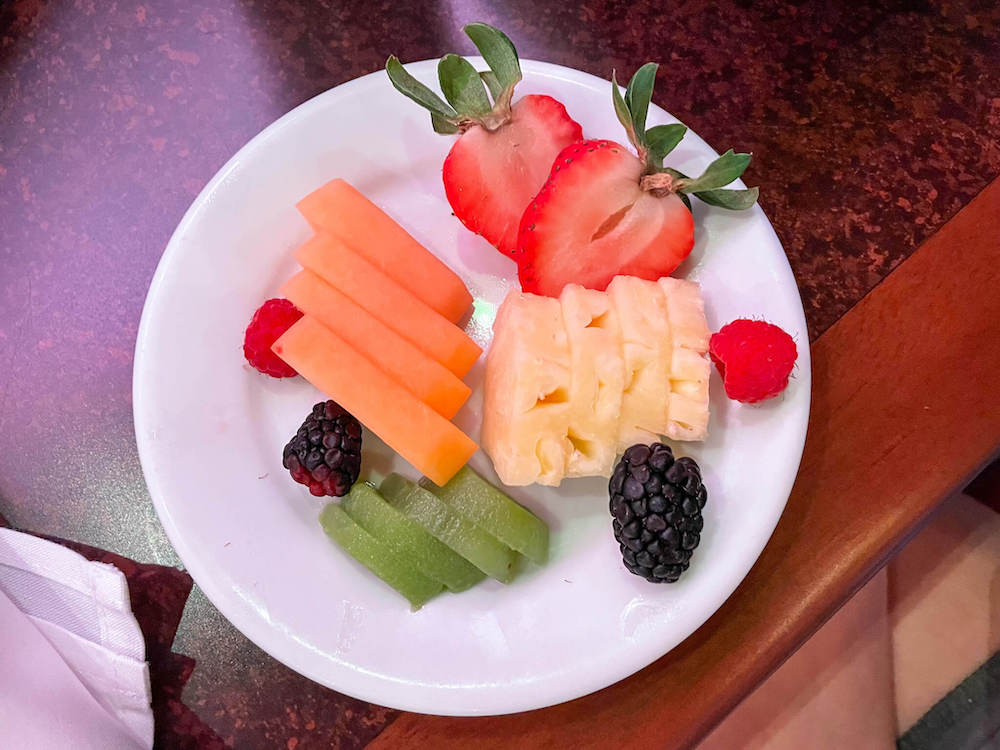 Image of a plate of freshly cut up fruit.