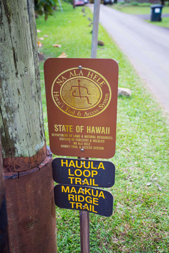 Image of a State of Hawaii sign for the Hauula Loop Trail and Maakua Ridge Trail on Oahu.