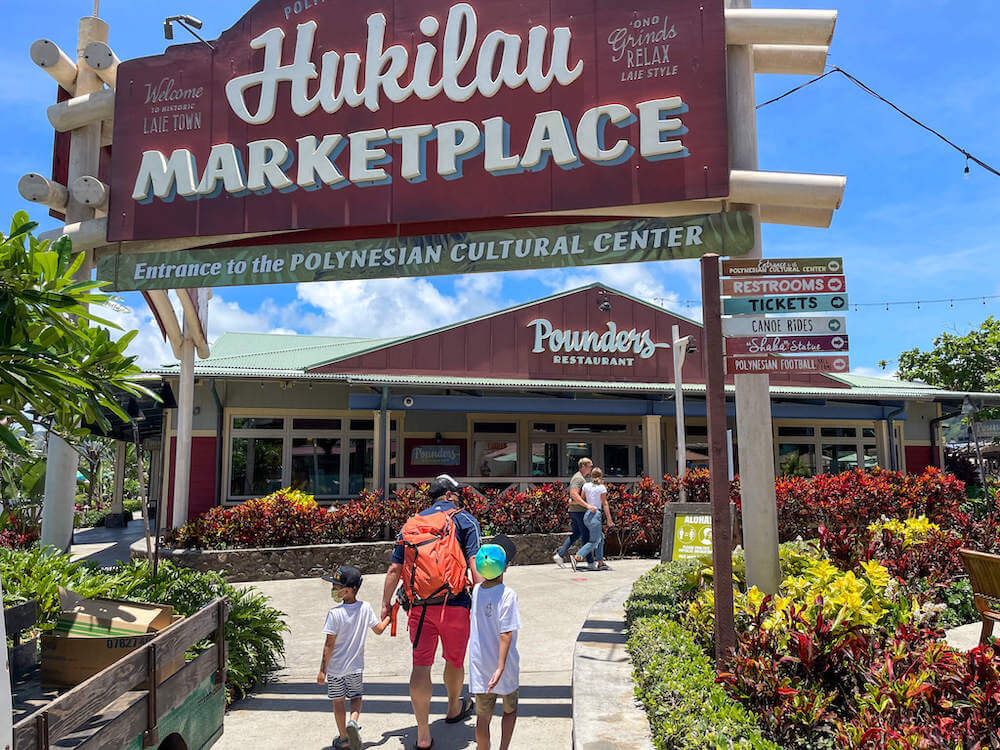 The Hukilau Marketplace is a North Shore Oahu attraction. Image of the Hukilau Marketplace sign and Pounders Restaurant.