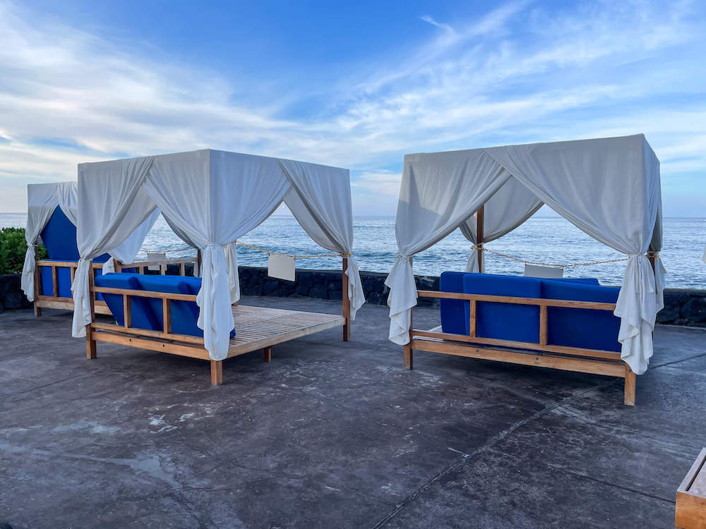 Image of three cabanas facing the ocean in Hawaii.