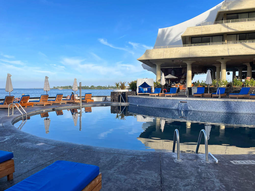 Image of a small pool with pool chairs next to the Royal Kona Resort.