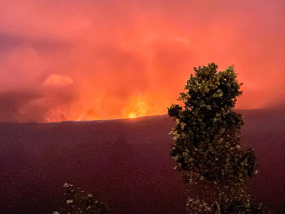 Image of fiery glow of lava inside a crater at Hawaii Volcanoes National Park on the Big Island.