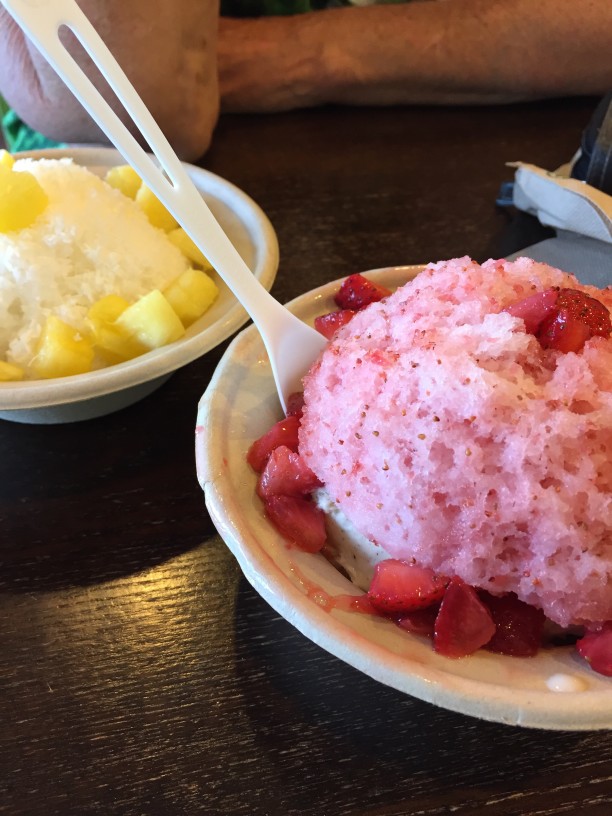 Image of two bowls of shave ice topped with fresh fruit.