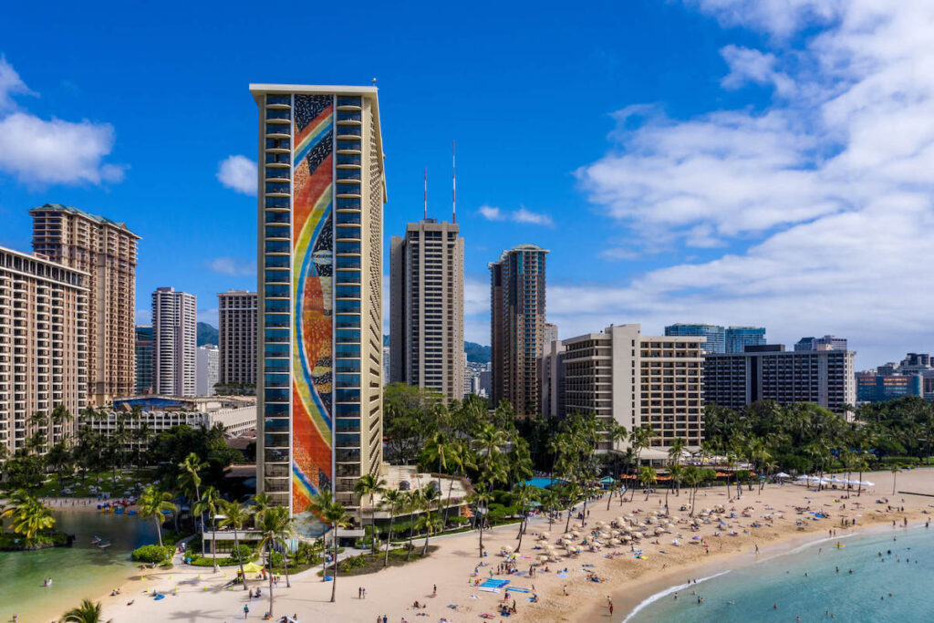 Read this honest Hilton Hawaiian Village review by top Hawaii blog Hawaii Travel with Kids. Image of the Rainbow Tower on Waikiki Beach