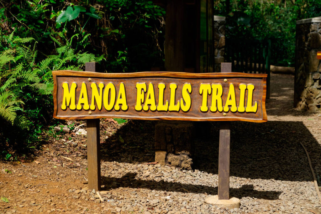 Find out if it's worth doing the Manoa Falls hike with kids by top Hawaii blog Hawaii Travel with Kids. Image of the Manoa Falls Trail sign.