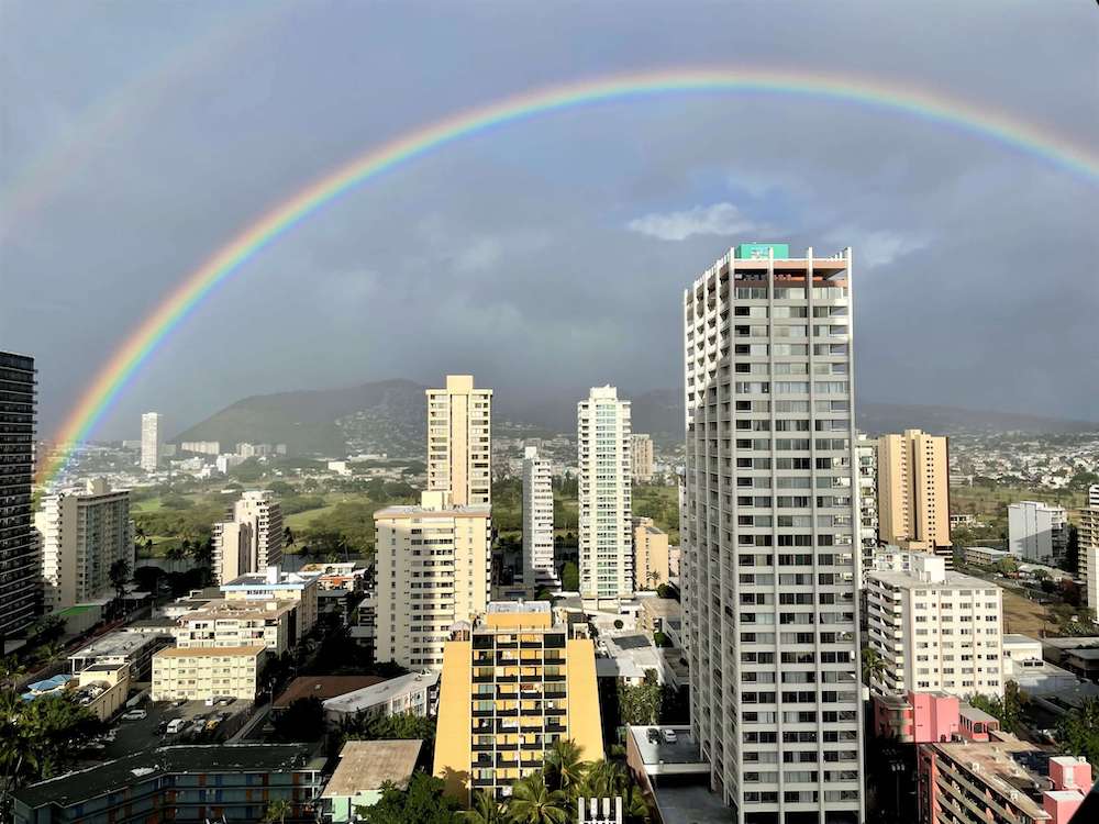 Image of a full rainbow over Honolulu as seen from a room at the Hyatt Regency Waikiki.