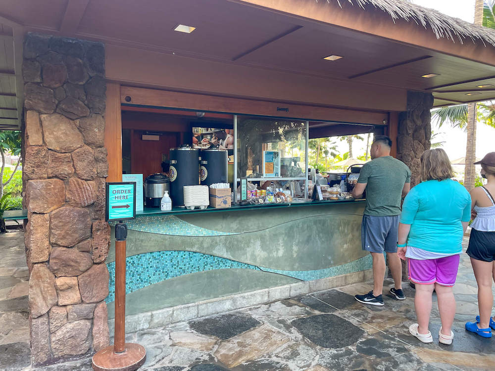 Image of people standing in line at an outdoor coffee bar at Aulani.