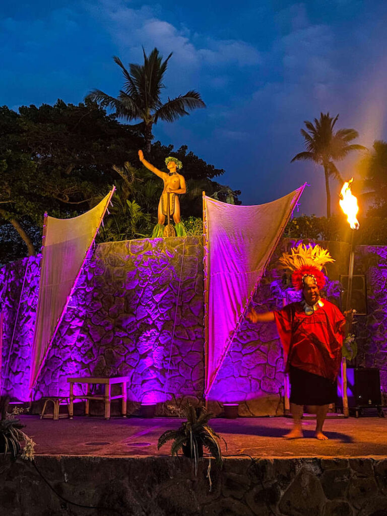 Image of two men on stage holding fire at a Maui Luau.