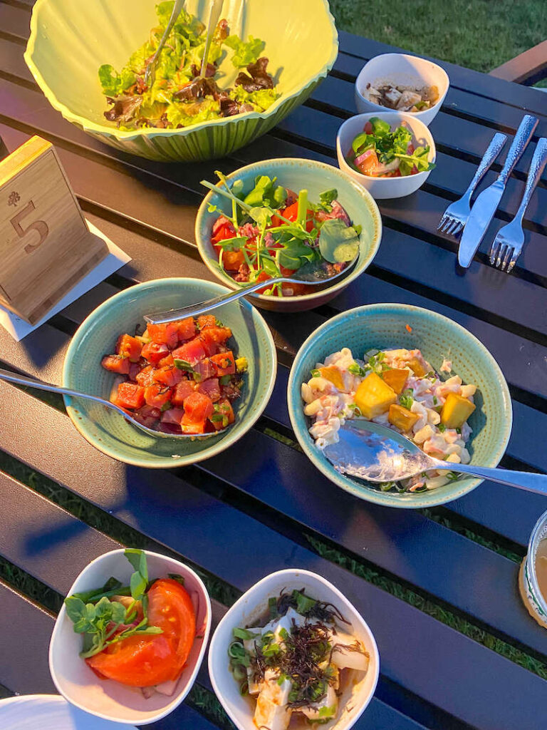 Image of a bunch of Hawaiian food in separate bowls on a table.