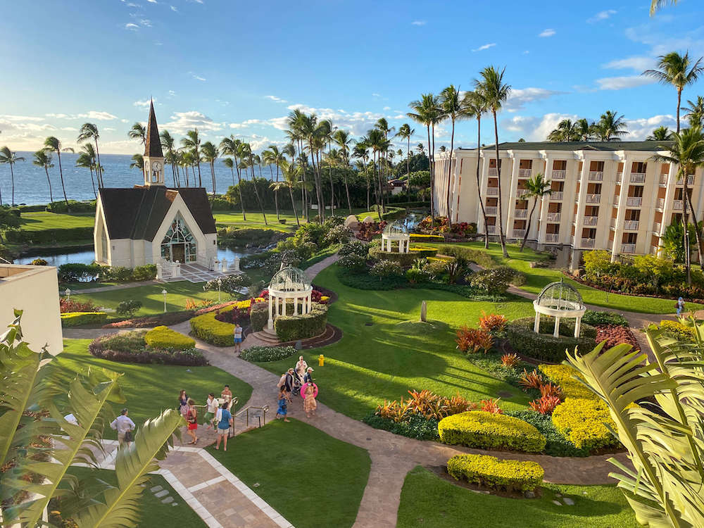 Image of a beautiful Maui resort with a little chapel and ocean in the background.