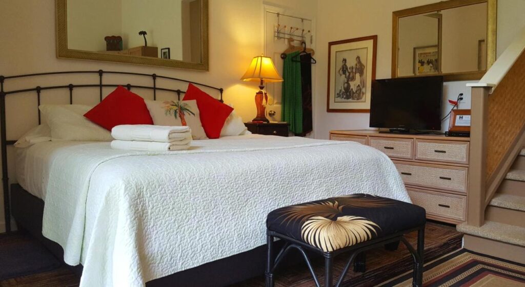 Image of a white bed in a downstairs room in Hana Maui.