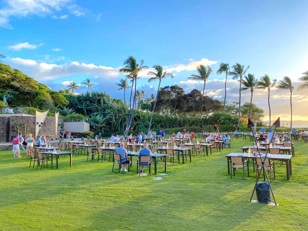 Image of tables set out on a lawn for the Grand Wailea Luau on Maui Hawaii.