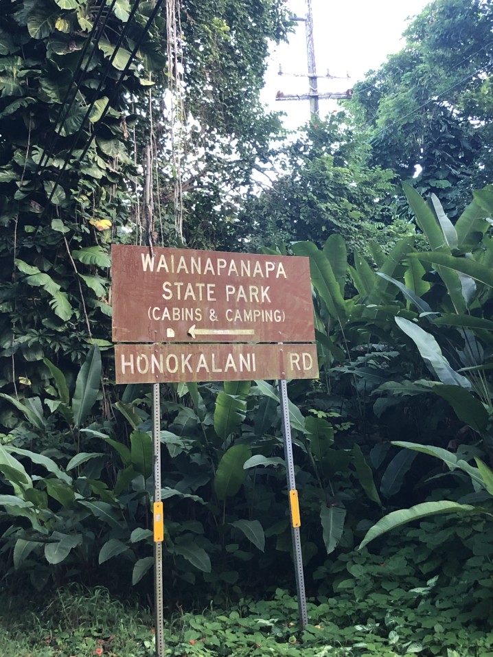 Image of the rusty brown sign for Waianapanapa State Park on Honokalani Road in Maui.