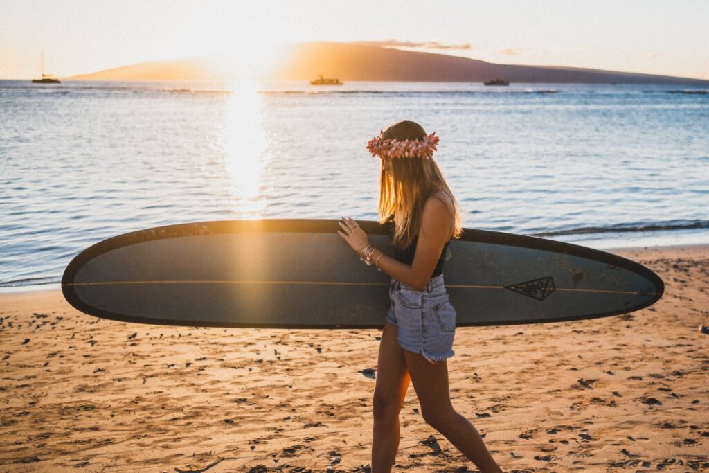 Image of a surfer girl in Lahaina at sunset