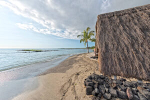 Find out the best beaches on the Big Island of Hawaii for kids recommended by top Hawaii blog Hawaii Travel with Kids. Image of Kaloko-Honokohau National Historical Park with a hut on the beach