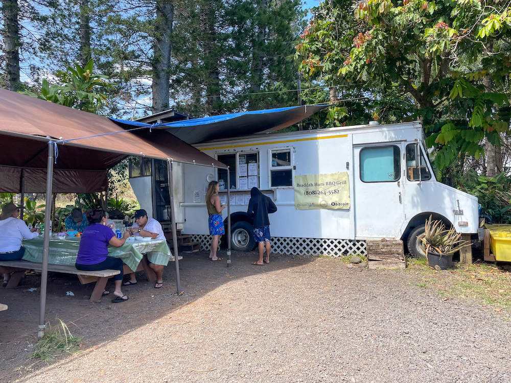 Image of a food truck next to a covered picnic area in Hana Maui.