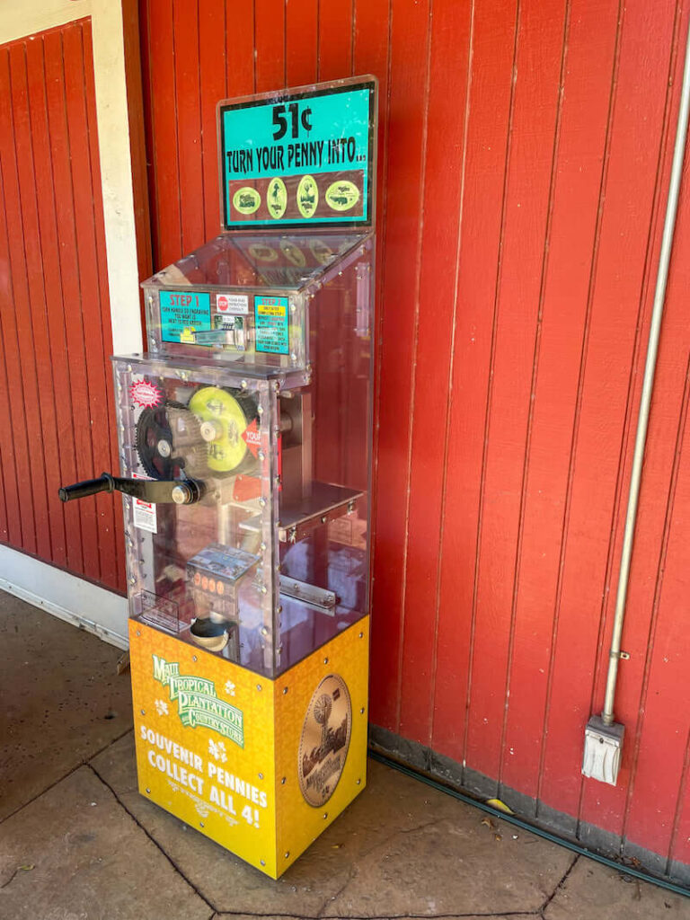 Image of a yellow souvenir penny machine at Maui Tropical Plantation in Hawaii.