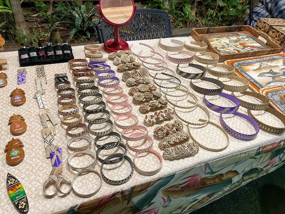 Image of a table with lauhala woven headbands and bracelets.