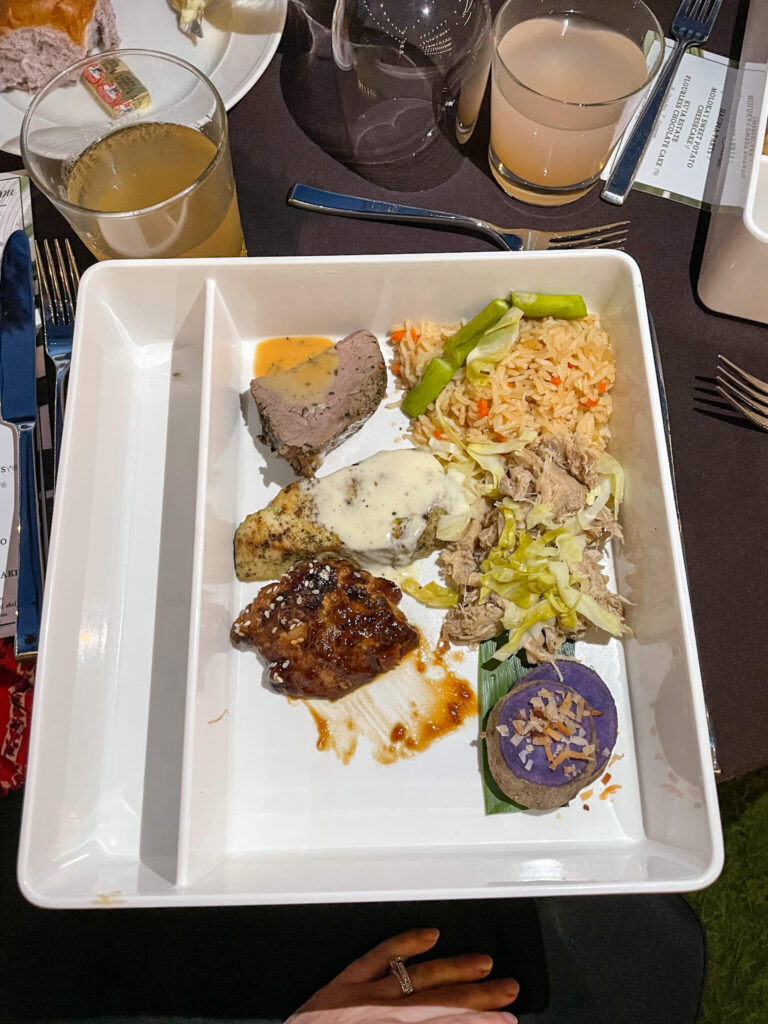 Image of a white tray with piles of different Hawaiian food on it.