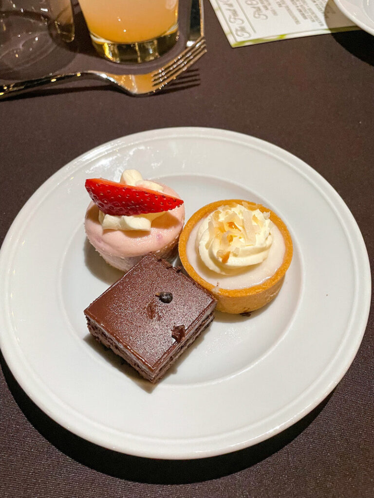 Image of a white plate with three little desserts on it.