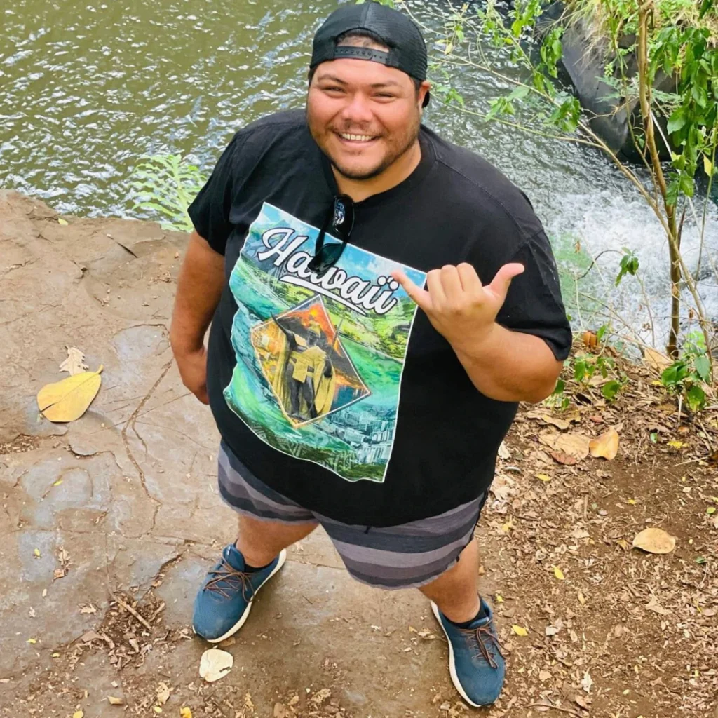 Image of a man waving a shaka in Hawaii