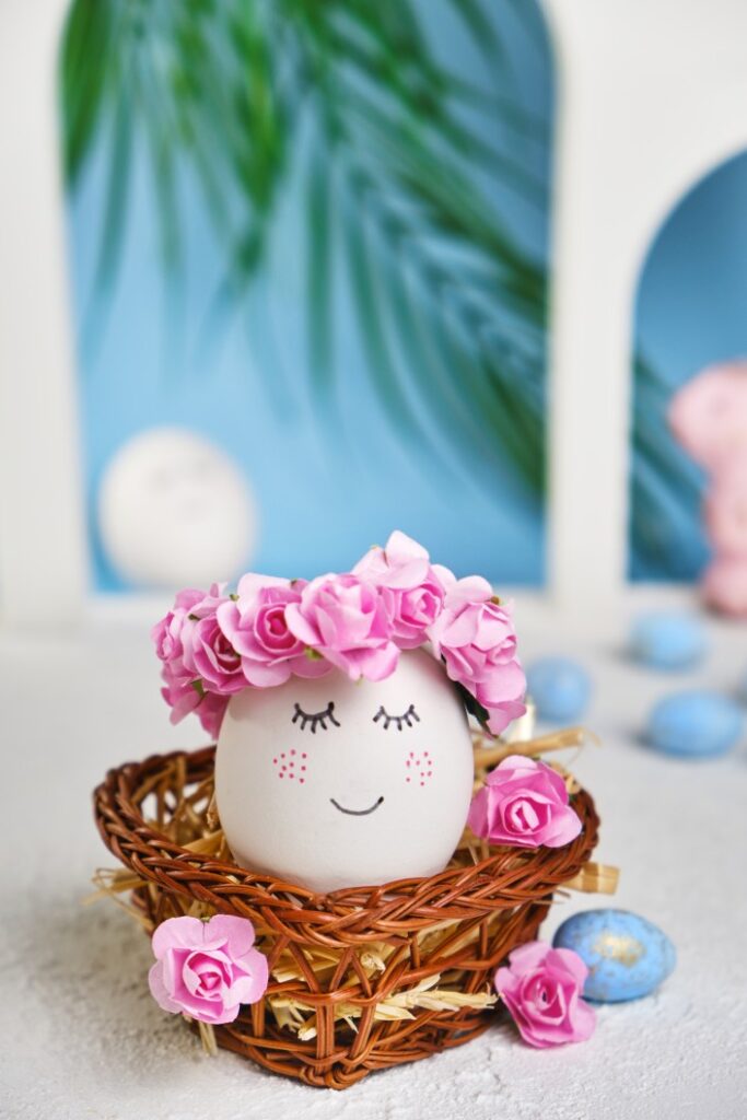 Image of a white egg decorated with flowers with a tropical background.