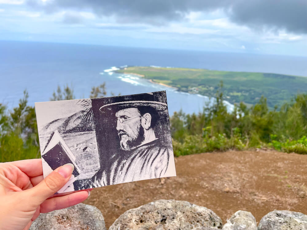 You'll definitely want to stop at Kalaupapa Lookout on a Maui to Moloka'i day trip. Image of a black and white postcard of Father Damien with the Kalaupapa settlement in the background.