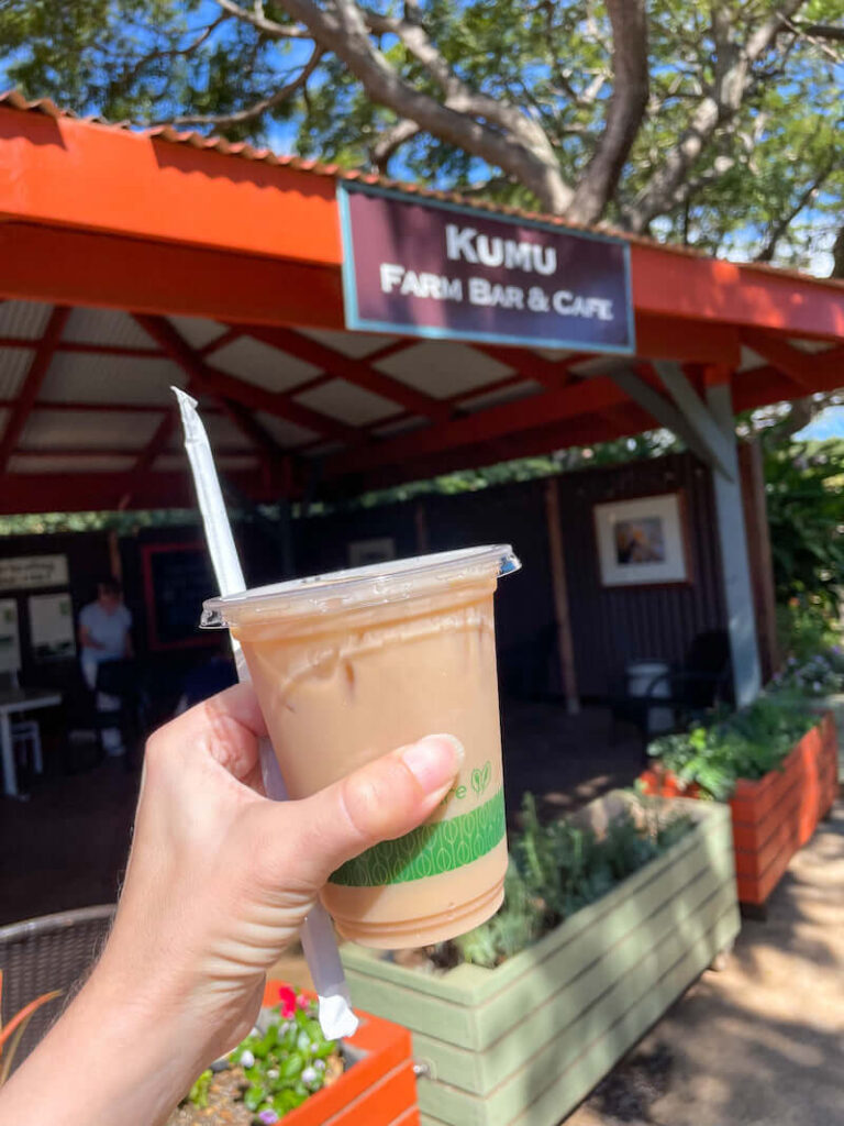 Image of an iced soy chai tea latte in front of the Kumu Farm Bar & Cafe at Maui Tropical Plantation in Hawaii.