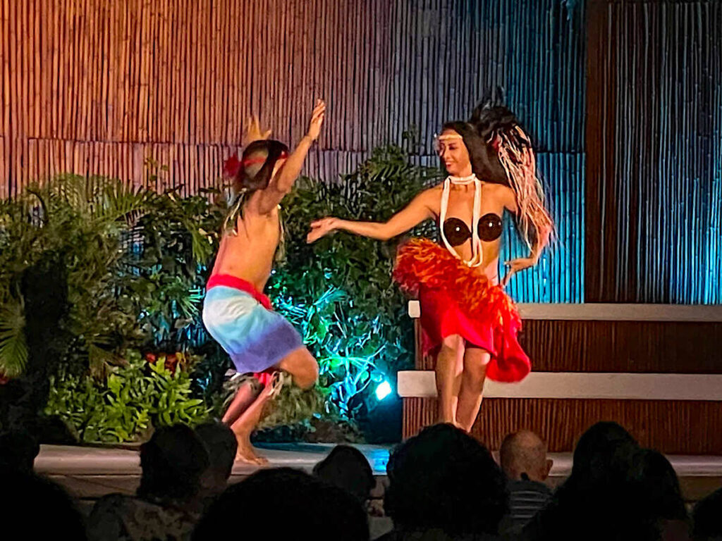 Check out this honest Myths of Maui luau review by top Hawaii blog Hawaii Travel with Kids. Image of a man and woman doing Tahitian dancing at a luau on Maui.