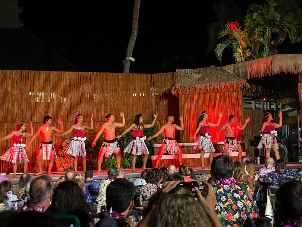 Image of men and women doing Maori dancing from New Zealand at the Myths of Maui luau in Hawaii.