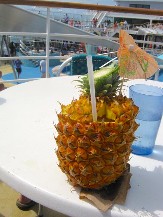 Image of a pina colada in a carved out pineapple.