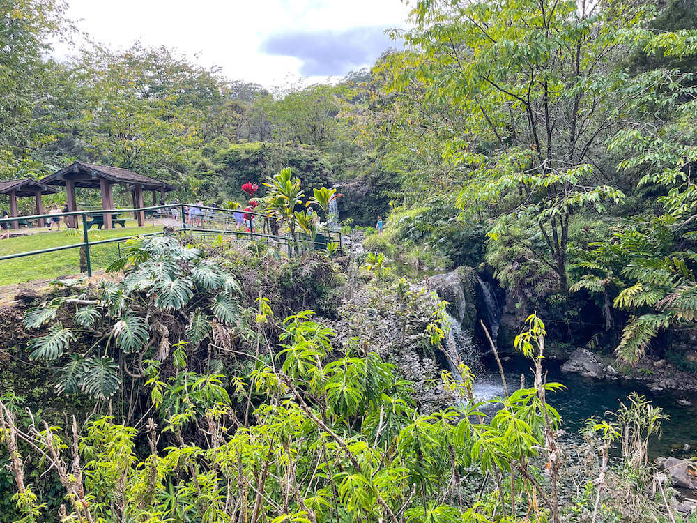 Image of two waterfalls, picnic shelters, and lots of foliage at Pua'a Ka'a Falls on Maui's Road to Hana.