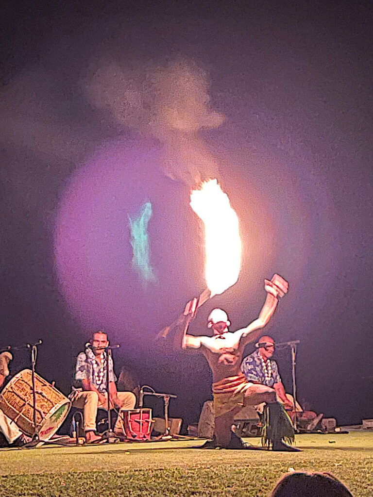 Image of a man attempting to eat fire at a luau in Maui Hawaii.