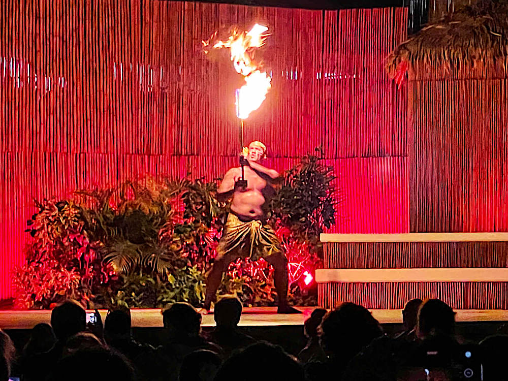 Image of a man with a long knife that's on fire at the Myths of Maui luau in Hawaii.