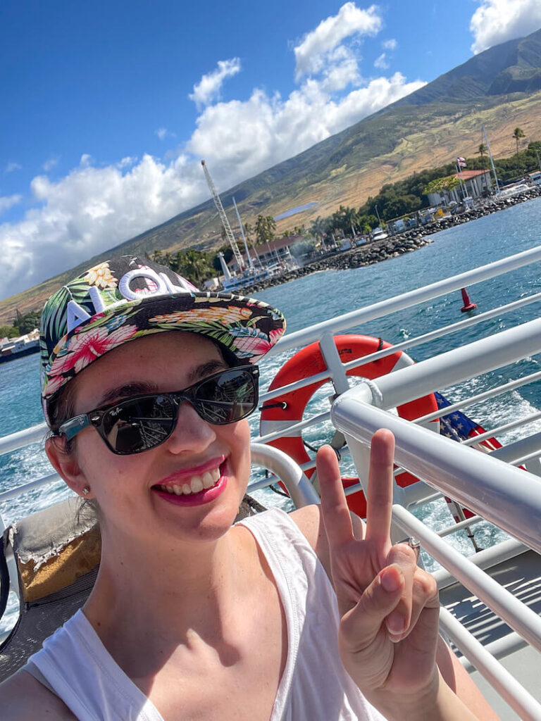 Image of a woman taking a selfie on the upper deck of the Maui ferry.