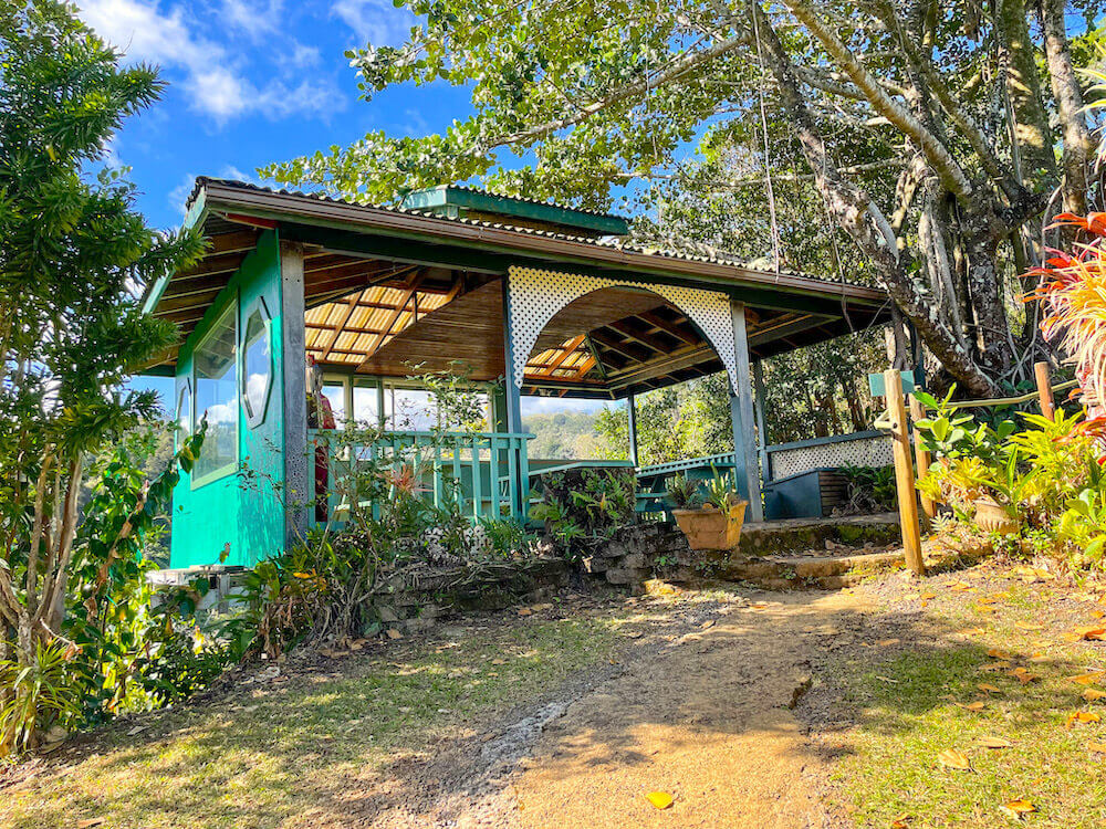 Image of a teal building with picnic tables inside